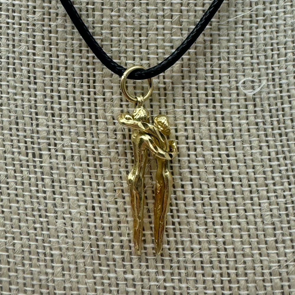 14k, vintage, lovers pendant on cord - weighs 4.4 grams